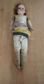A Victorian Armand Marseille bisque headed doll having sleep blue eyes, painted eyebrows, open mouth