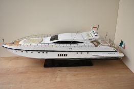 A wooden and plastic scale model, Mangusta 108 Italian Cabin Cruiser, on fitted stand, length 87cm