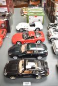 Four Burago 1:18 scale Die-casts, Porsche Carrera 911 (1993), Aston Martin Vanquish, Chevrolet