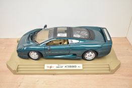 A Maisto 1:12 scale Die-cast, Jaguar XJ220 (1992), on plastic display stand