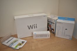 A Nintendo Wii Console with MarioKart Game and Wheel along with an extra Controller and a
