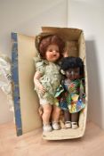 A Pedigree Celluloid Walking Doll, fully clothed, length 55cm in original box with wrapping paper
