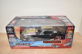 A Maisto 1:12 scale Pro Rodz Radio Controlled 1967 Ford Mustang GT, in original display box, appears