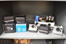 A collection of Polaroid Cameras. A boxed Polaroid Spirit 600CL, a boxed Polaroid Sun 600 LMS, a