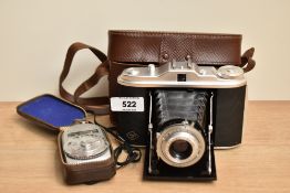 An Agfa Solette folding camera with a Sekonic light meter