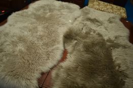 Two sheep skin rugs, labelled Dunelm 100% sheepskin