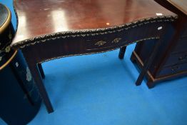 A late 19th or early 20th Century mahogany fold over tea table having shaped and carved edge,