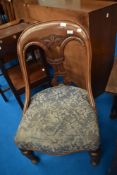 A Victorian mahogany nursing chair of interesting design with strap style turned design ,