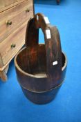 A traditional wooden milk pail