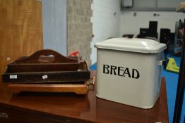 A vintage enamelled bread bin and selection of cutlery trays and serving trays