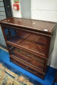 A two tier Globe Wernicke style stacking bookcase having drawer base