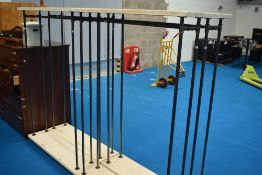 A set of four modern shop clothes , with piping style rails and supports , on castors with brakes,