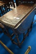 A 19th Century oak gateleg occasional table having carved decoration of turned frame