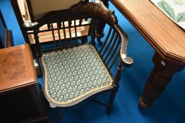 An Edwardian corner chair having inlaid decoration, frame a bit loose, possibly later upholstered