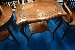 A late 19th Century mahogany occasional table having shaped top and undetier with chip carved
