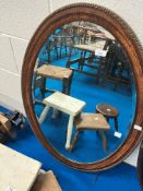 An oak framed oval wall mirror