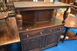A traditionql dark stained oak court cupboard