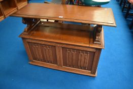 A traditional oak monks bench having linen fold decoration to panels , dimensions approx W106 D44