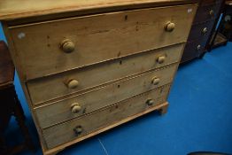 A 19th Century stripped pine chest of four long drawers
