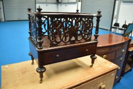 A 19th Century mahogany canterbury having fretwork panels and turned supports, with drawer to
