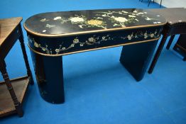 An oriental ebonised console or dressing table having painted naturalistic and bird decoration
