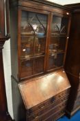 A reproduction mahogany bureau bookcase
