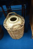 A vintage stoneware flagon , in wicker basket, stamped for Doulton and Clatyton and Jowett