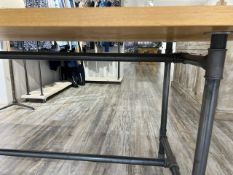 A modern shop display table , with piping style rails and supports , golden oak top approx. 200 x