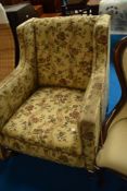 A Howard style upholstered armchair having heavy frame