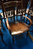 A late 19th or early 20th Century oak carver chair of interesting design having markings to shoulder