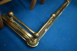 An adjustable brass fire fender