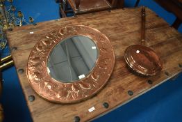 An Arts and Crafts copper framed mirror, Keswick School of Industrial Art , having repousse