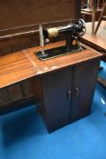 A vintage Singer sewing machine in cabinet
