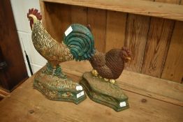 Two cast iron door stops, modelled as cock and hen