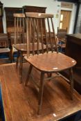 A pair of dark stained stick back kitchen chairs, similar to Ercol