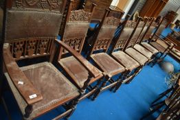 A set of eight (six plus two) Oak Arts and Crafts dining chairs having vine decoration, frames