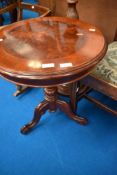 A reproduction occasional table on turned pedestal