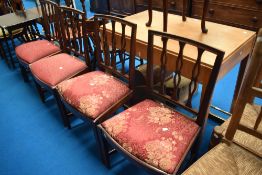 A set of four early 20th Century mahogany dining chairs having upholstered drop in seats