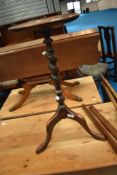 A traditional oak wine table having circular top on twist column and triple splay legs, height