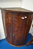 A 19th Century oak bow fronted corner cupboard
