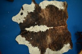A traditional cow hide rug, possibly Hereford