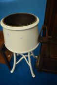 A traditional painted jardiniere stand