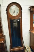 An early 20th Century oak longcased clock with arabic numeral dial on semi silvered face, height