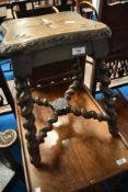 A 19th Century stool having carved top and twist legs and frame
