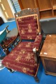 A Victorian stained frame armchair with later script upholstery in burgundy and gold