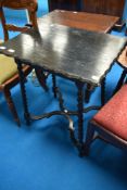 A late Victorian dark stained occasional table on twist legs and X frame