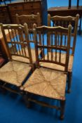 A set of four traditional spindle back chairs havinng rush seats