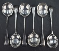 A set of four George V silver Old English pattern soup spoons, sold along with a further pair of