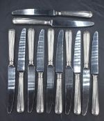 A set of twelve Elizabeth II silver handled knives, having a moulded step design, marks for