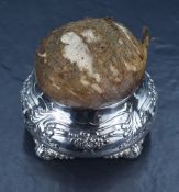 A Tiffany & Co. silver hat pin cushion, the silver base of squat bulbous form with embossed floral